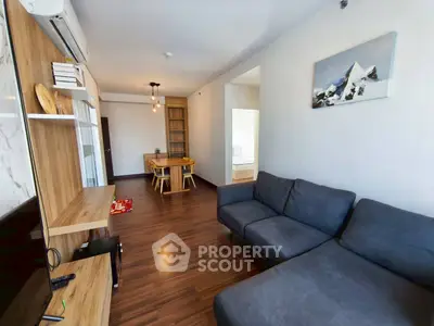 Modern living room with wooden flooring and cozy gray sofa