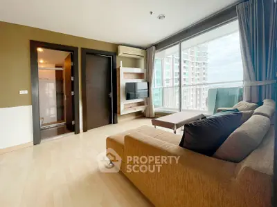 Spacious living room with modern decor and large windows offering stunning city views.