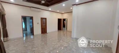 Spacious unfurnished living room with marble flooring and ceiling fan