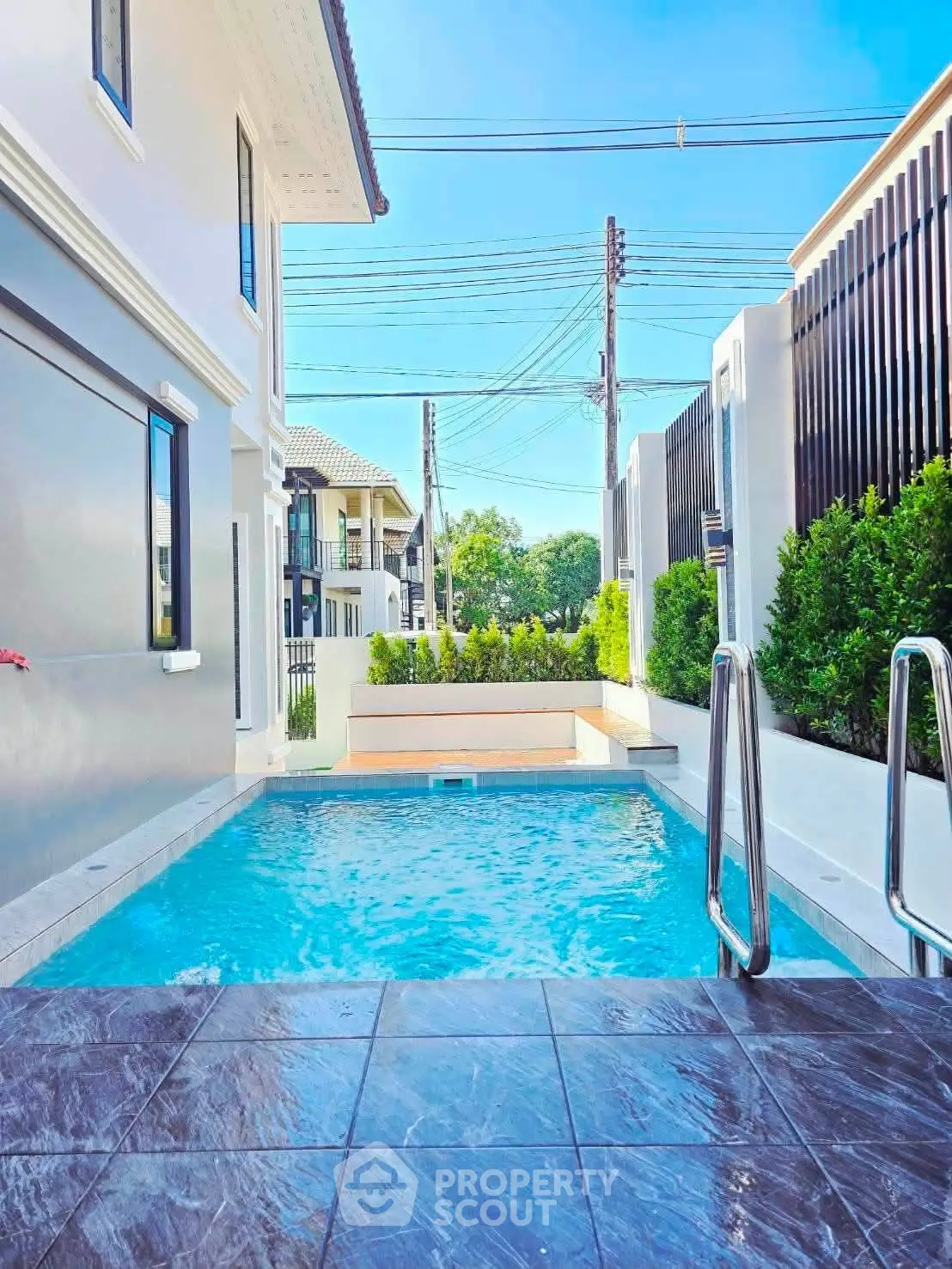 Luxurious private pool area with modern design and lush greenery, perfect for relaxation and entertainment.