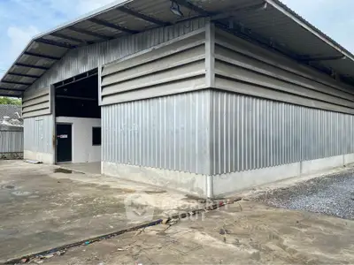 Spacious industrial warehouse with metal siding and concrete flooring, ideal for storage or manufacturing.