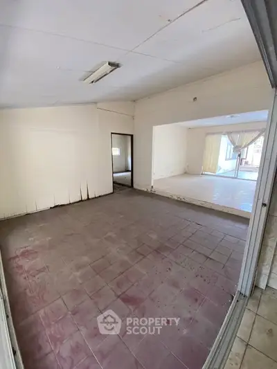 Spacious interior with tiled floors and large windows for natural light.