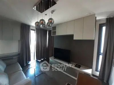 Modern living room with sleek furniture and stylish lighting fixtures.