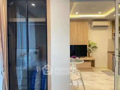 Modern living room with sleek furniture and stylish kitchen in open layout apartment