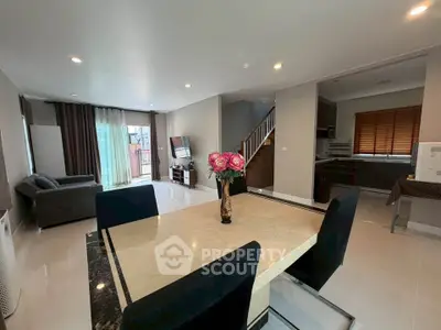 Spacious modern living room with elegant dining area and open kitchen, perfect for family gatherings.