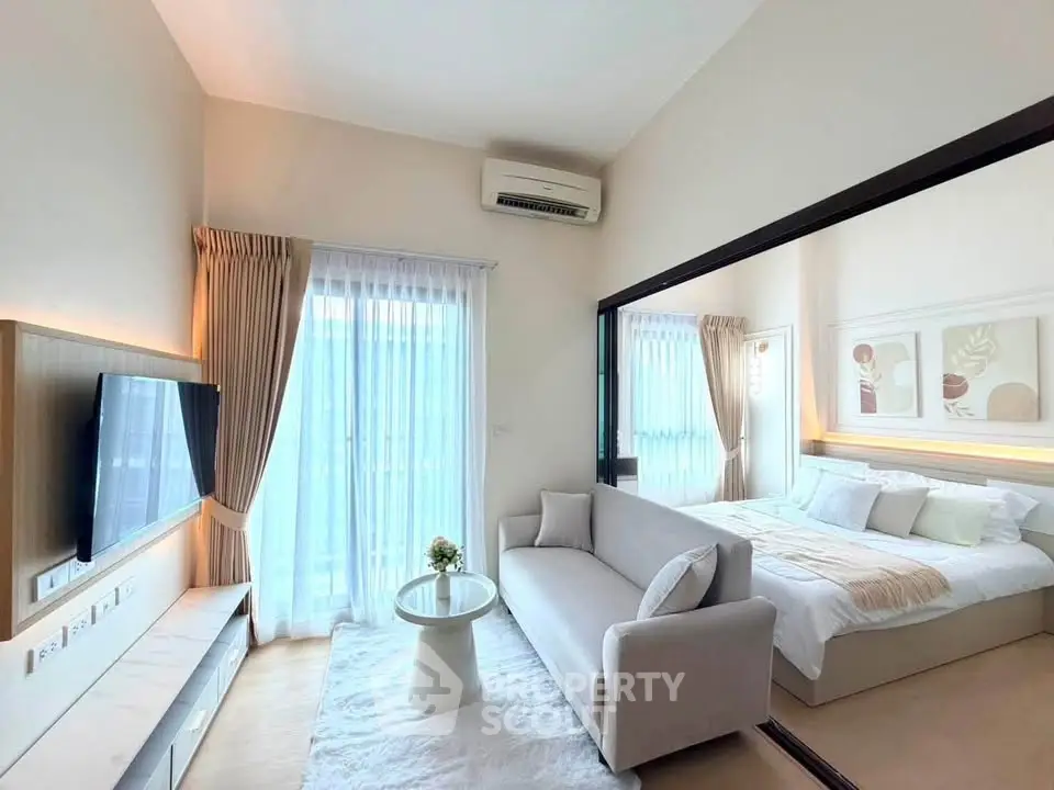Modern studio apartment with cozy living area and stylish bedroom