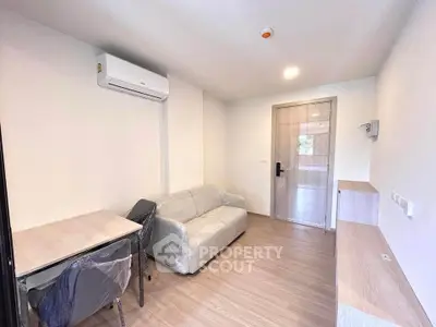 Modern living room with minimalist furniture and air conditioning in a cozy apartment.