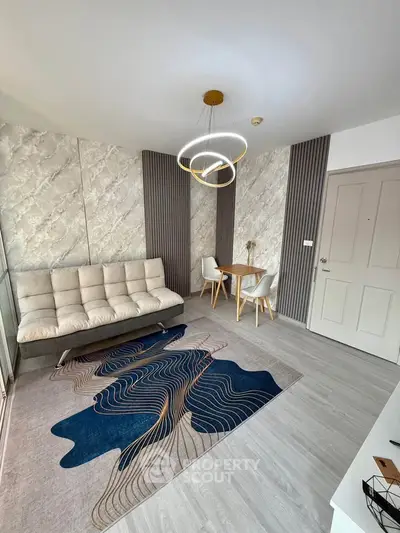 Modern living room with stylish decor and unique lighting, featuring a cozy sofa and elegant dining area.