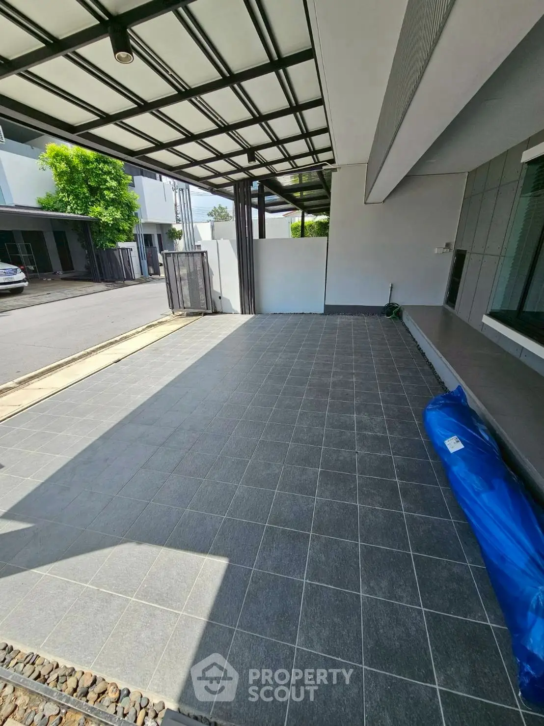 Spacious modern carport with sleek tiled flooring and covered roof