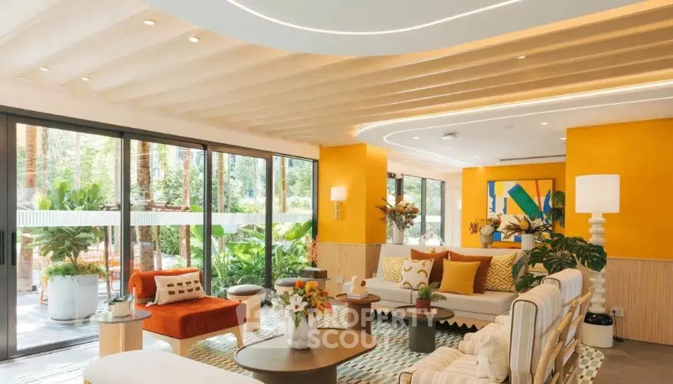 Luxurious living room with modern decor and large windows overlooking lush garden.