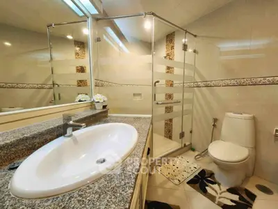 Modern bathroom with glass shower and granite countertop