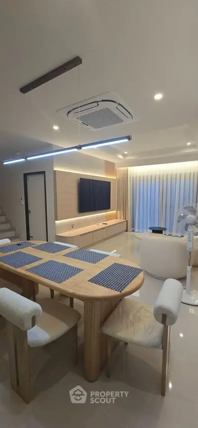 Modern living room with stylish dining area and elegant lighting