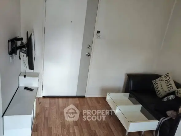 Cozy living room with modern decor and wall-mounted TV, perfect for relaxation.