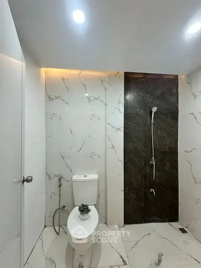 Modern bathroom with elegant marble tiles and sleek shower design