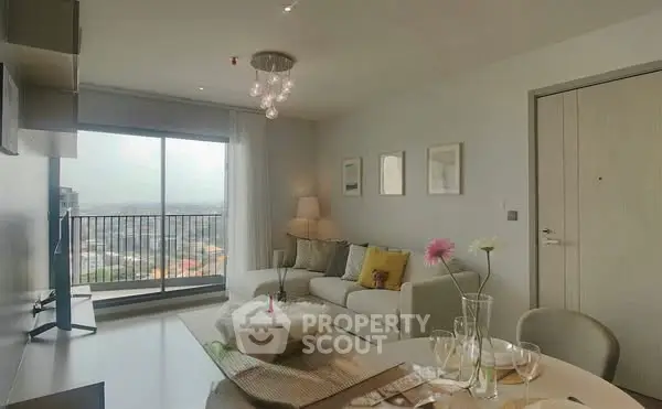 Modern living room with large window and stylish decor in high-rise apartment.