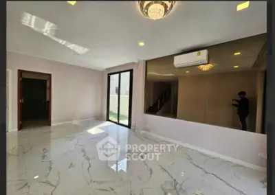 Spacious modern living room with marble flooring and large windows