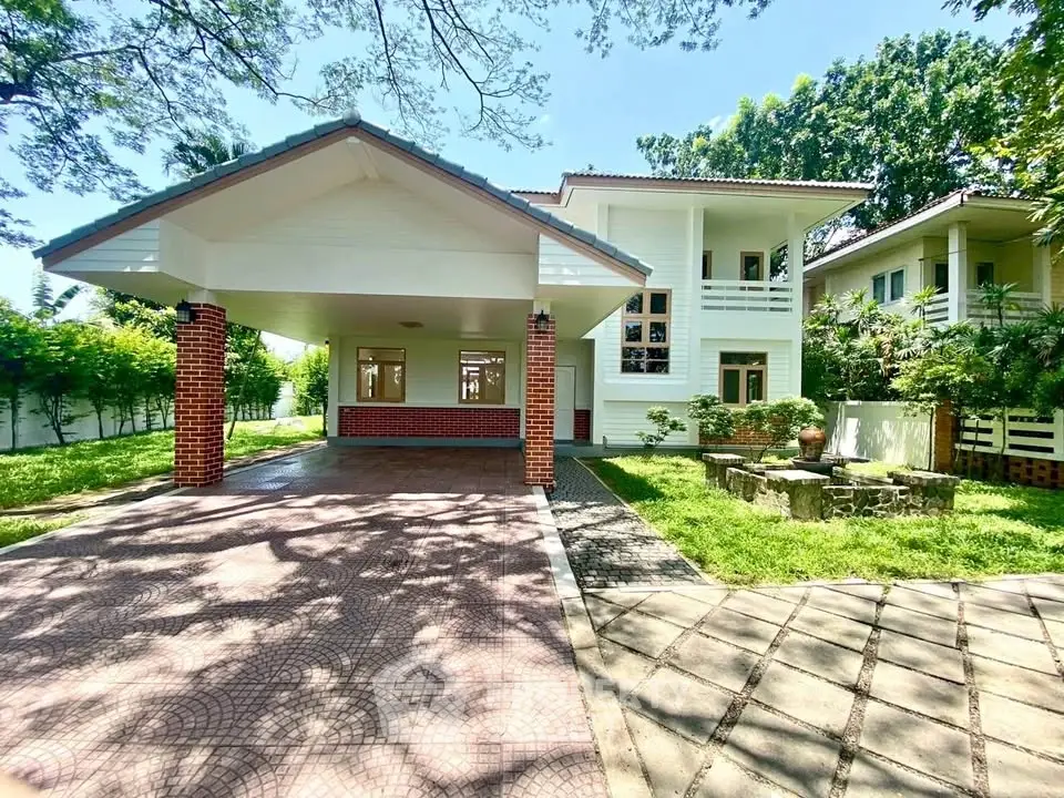 Charming two-story house with spacious driveway and lush garden