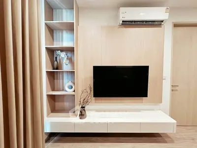 Modern living room with sleek TV setup and stylish shelving unit