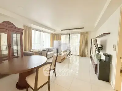 Spacious living room with elegant furniture and large windows in a modern apartment.