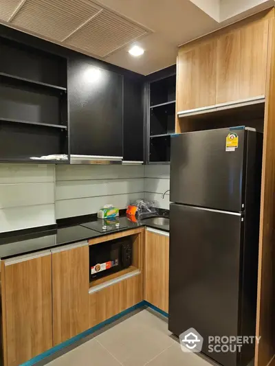 Modern kitchen with sleek black appliances and wooden cabinetry