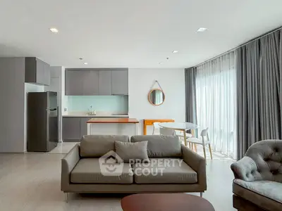 Modern open-plan living room with sleek kitchen and stylish furniture