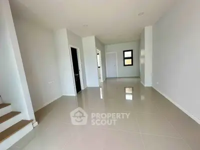 Spacious modern interior with sleek tile flooring and neutral walls, perfect for customization.