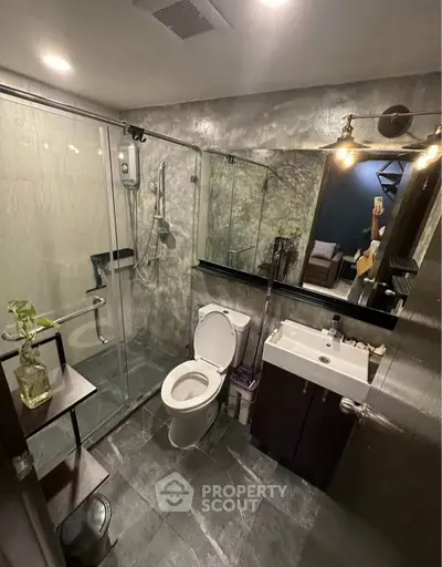Modern bathroom with glass shower, sleek fixtures, and stylish decor