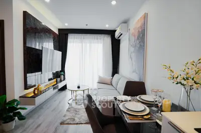 Modern living room with elegant decor and large window for natural light