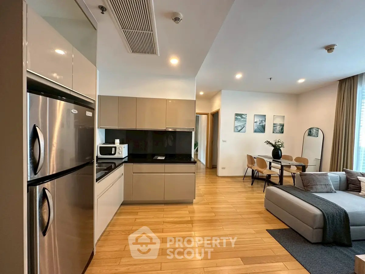 Modern open-plan kitchen and living room with sleek appliances and stylish decor