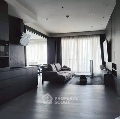 Modern living room with sleek design and large windows offering natural light.