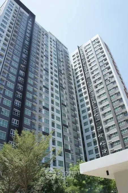 Modern high-rise apartment building with sleek design and large windows
