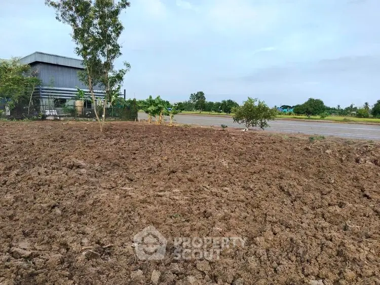 Expansive plot of land with potential for development, featuring open space and greenery.