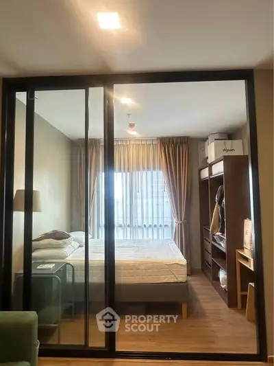 Cozy bedroom with glass partition and natural light