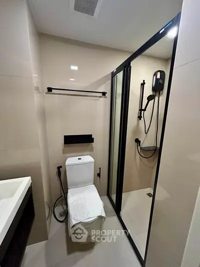 Modern bathroom with sleek shower and toilet in contemporary apartment