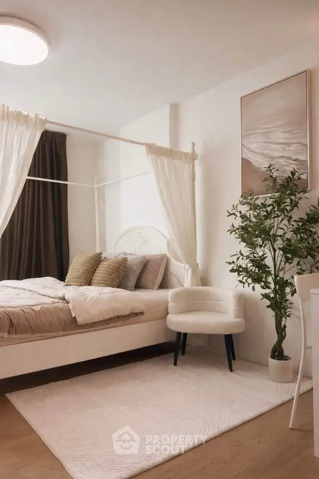 Elegant bedroom with canopy bed, cozy chair, and stylish decor in a modern apartment.