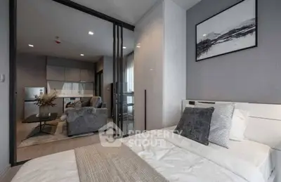 Modern bedroom with sliding glass doors and cozy living area view
