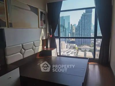 Modern bedroom with stunning city view from large window, featuring stylish decor and hardwood floors.