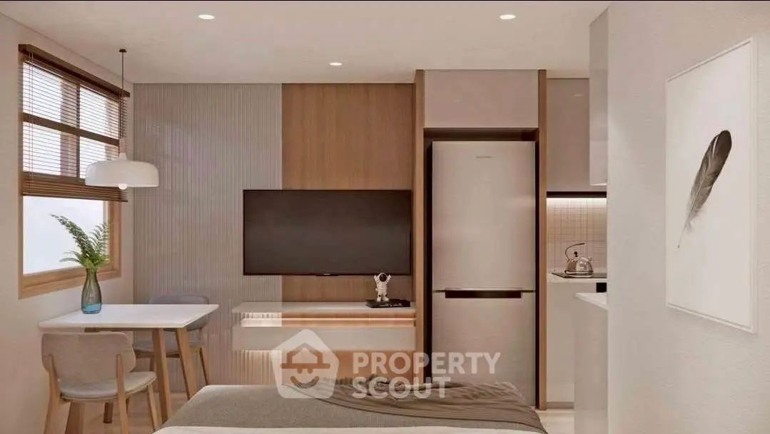 Modern studio apartment with stylish decor, featuring a cozy dining area, wall-mounted TV, and sleek kitchen appliances.