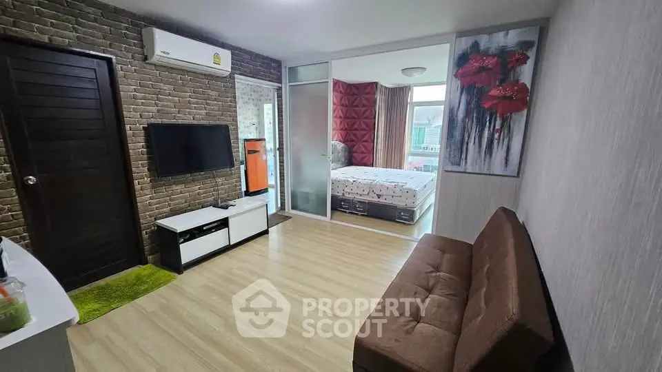 Modern studio apartment with stylish decor and open layout, featuring a cozy living area and bedroom.