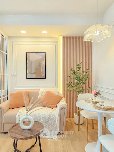 Charming living room with cozy sofa, elegant decor, and stylish dining area in modern apartment.