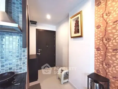 Stylish apartment entrance with modern kitchen and elegant decor