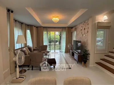 Spacious living room with elegant decor and garden view, featuring modern furniture and ambient lighting.