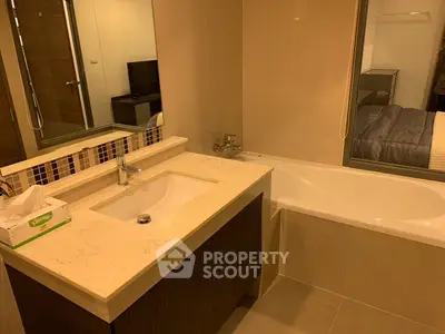 Modern bathroom with elegant vanity and bathtub in a stylish apartment.