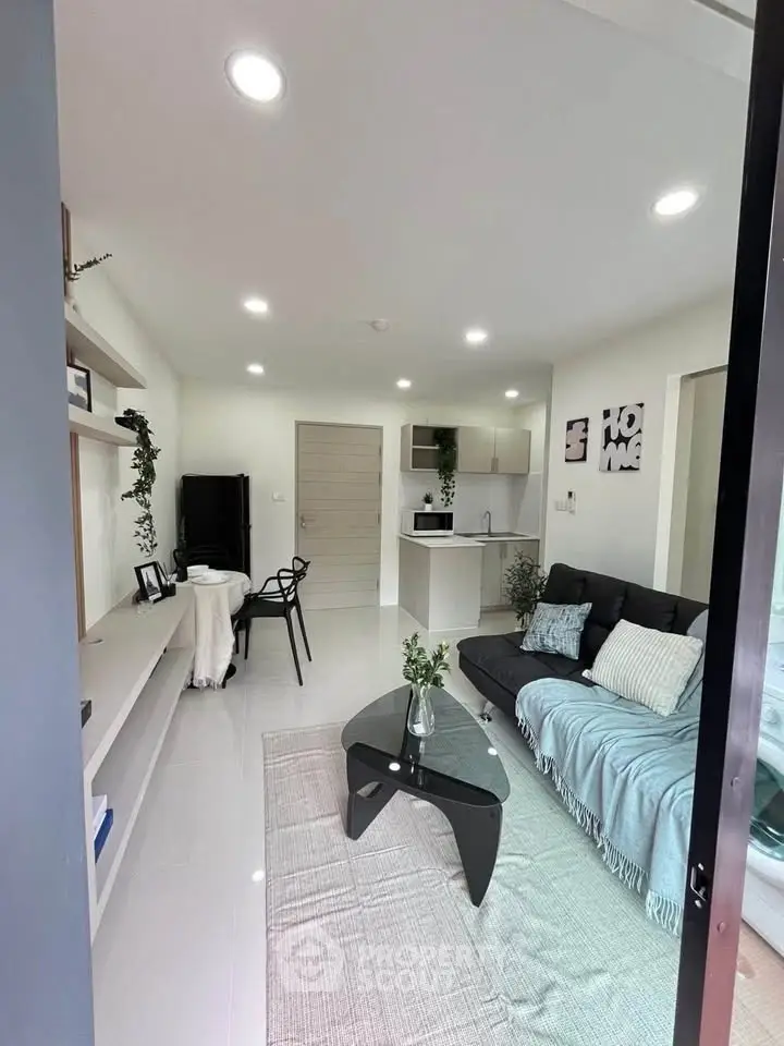 Modern living room with sleek furniture and open kitchen layout