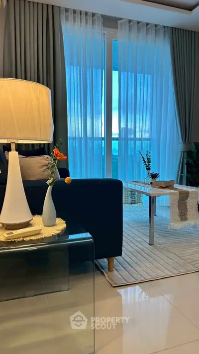 Elegant living room with modern decor and large windows offering natural light.