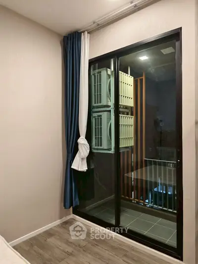 Modern bedroom with balcony view and air conditioning units