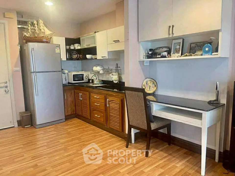 Cozy kitchen with wooden cabinets and modern appliances in a stylish apartment.