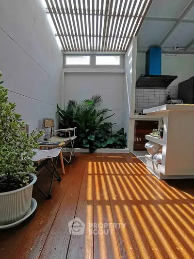 Charming indoor patio with natural light and modern kitchen view