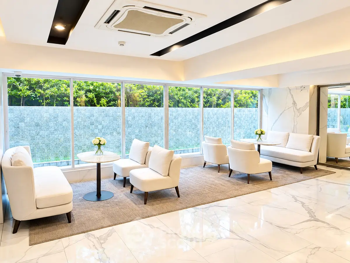 Luxurious modern lobby with elegant seating and large windows overlooking greenery.