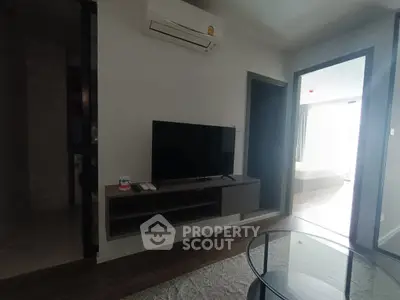 Modern living room with sleek TV setup and air conditioning